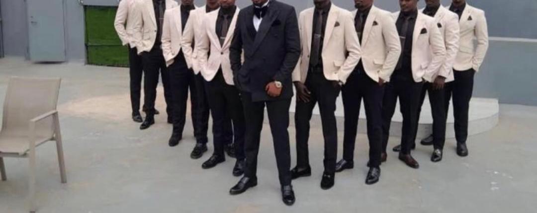 Groomsmen in matching cream and black suits