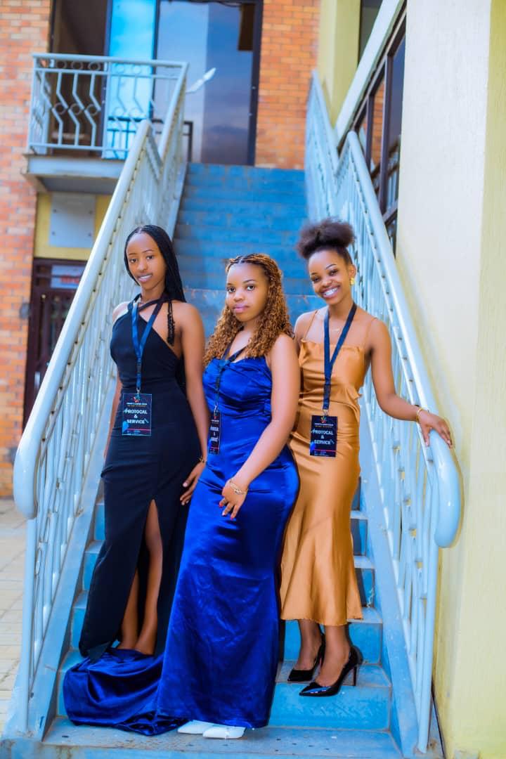 Protocol hostesses in evening gowns with badges
