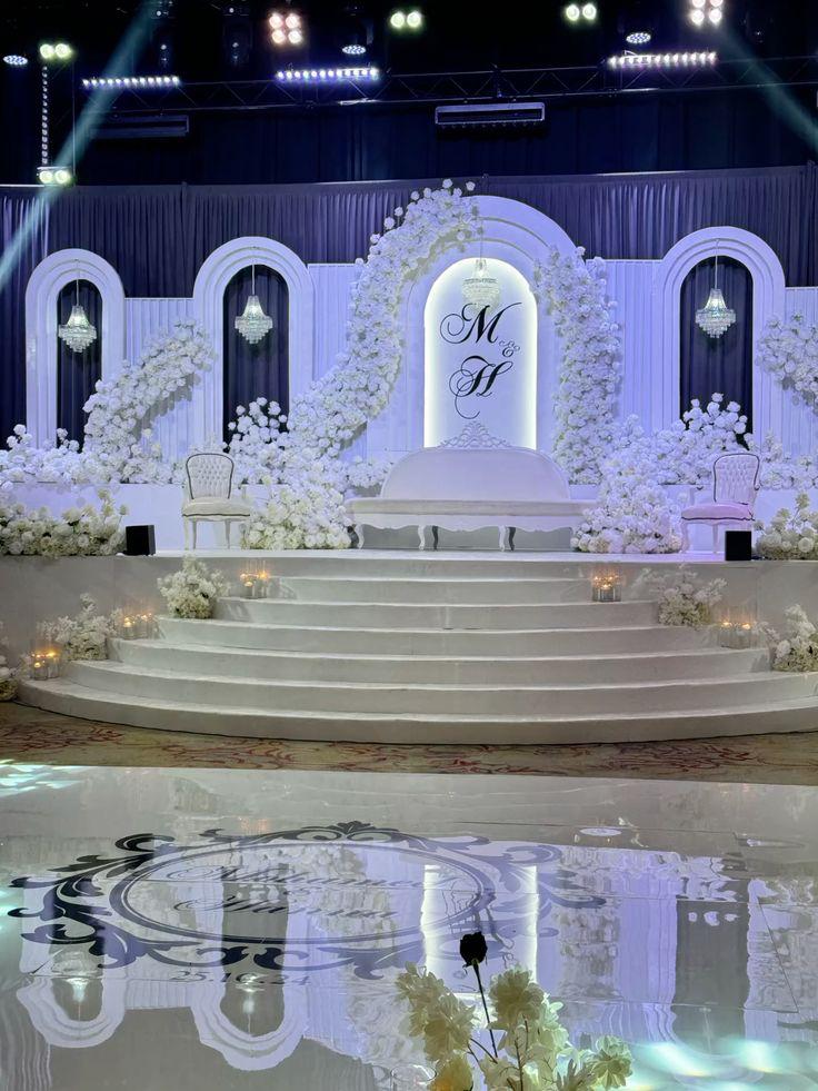 Luxury wedding stage with white florals and mirror floor